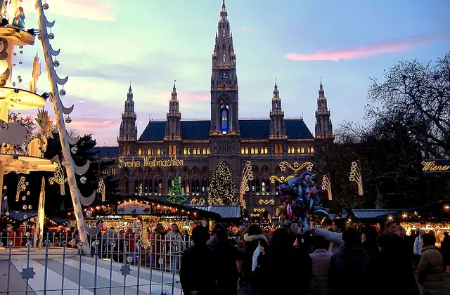 Vienna Christmas Market with the Rathaus behind illuminated stalls